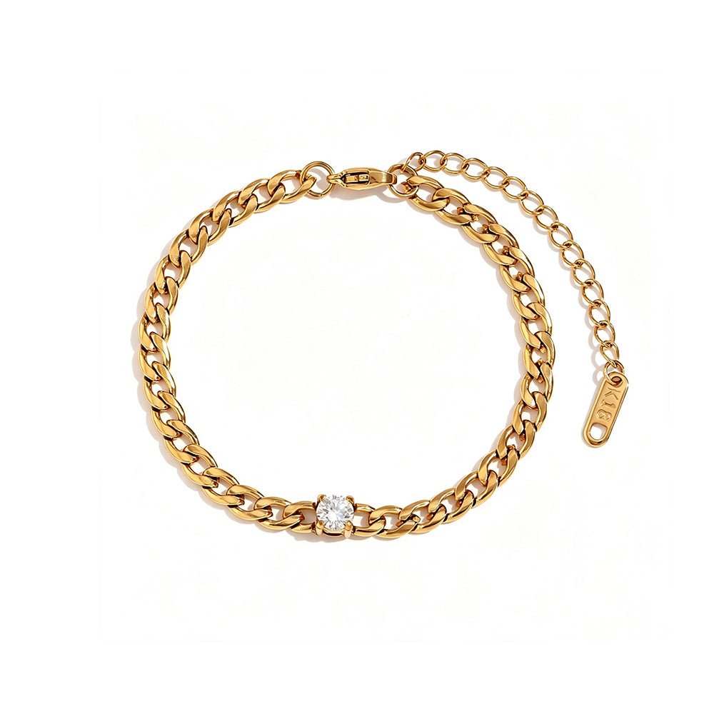 Gold Cuban link bracelet with round prong-set stone on white background, full bracelet circle shown with lobster clasp, extender chain and engraved tag, round stone centered in curb links, soft warm shadow
