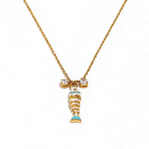 White enamel fish pendant necklace on gold cable chain, crystal accent detail, white background
