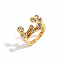Gold clear stone scatter open band ring on white background, angled view showing nine bezel-set clear stones in scattered arrangement, open band gap visible, clean shadow

