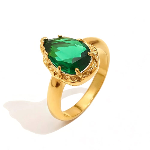 Gold green teardrop stone halo cocktail ring on white background, deep green faceted teardrop stone in multi-prong gold halo setting, tapered gold band, soft shadow

