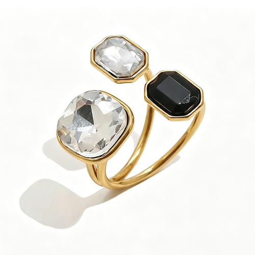 Gold triple stone open cocktail ring in Mist colorway on white background, large clear crystal cushion stone with translucent white and jet black octagon stones in graduated bezel settings, open band with warm shadow
