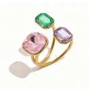 Gold triple stone open cocktail ring in Orchid colorway on white background, large rose pink cushion stone with lavender and bright green octagon stones in graduated bezel settings, open band with warm shadow
