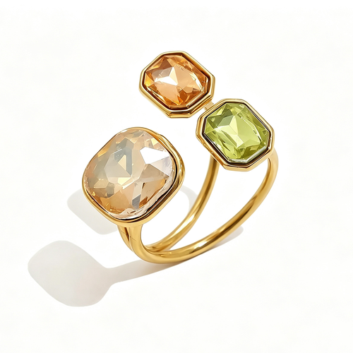 Gold triple stone open cocktail ring in Sahara colorway on white background, large translucent champagne cushion stone with amber and yellow-green octagon stones in graduated bezel settings, open band with warm shadow
