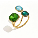 Gold triple stone open cocktail ring in Forest colorway on white background, large deep green cushion stone with ice blue and emerald green octagon stones in graduated bezel settings, open band with warm shadow
