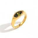 Gold marquise stone dome signet ring in green colorway on white background, deep olive green marquise-cut stone bezel-set in mirror-polished gold dome band, warm directional shadow
