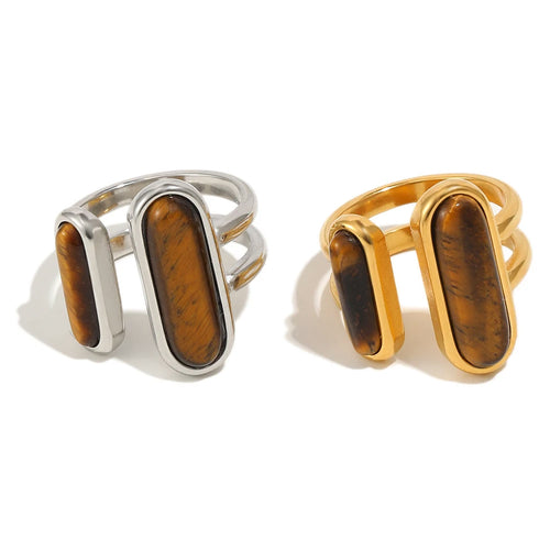 Dual tiger's eye open ring in gold and silver, two bezel-set oval stones on split open band, white background
