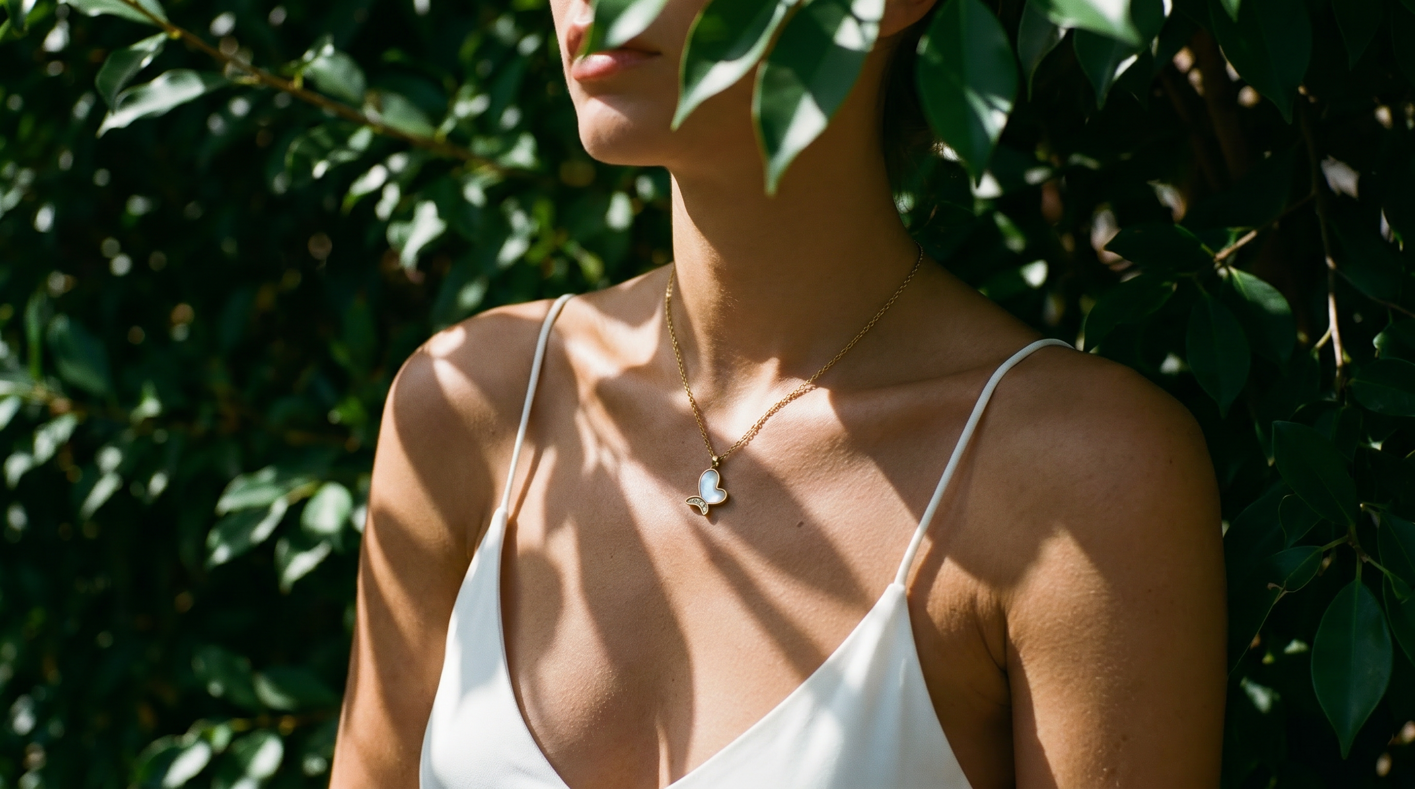 Close-up of butterfly pendant necklace in soft natural light — SEIYI fine jewelry