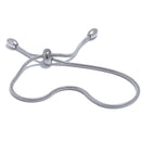 Silver snake chain slider bracelet on white background, S-curve layout showing barrel slider at center with two snake chain ends tipped with polished ovals, cool light with soft shadow
