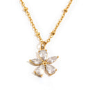 Crystal flower pendant necklace in gold, five CZ petals on beaded O-chain, white background
