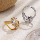 Gold marquise crystal ring front view and silver ring showing interior band structure, textured stone surface
