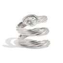 Spiral wrap ring in silver close-up, pear-cut crystal in smooth bezel at crown, rope-textured coiling band, white background
