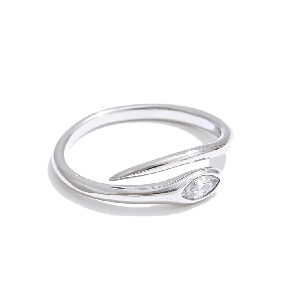 Silver marquise stone snake ring on white background, open adjustable band in three-quarter angle, bezel-set marquise-cut stone at snake head, tapered tail end and open gap visible, cool light with soft shadow
