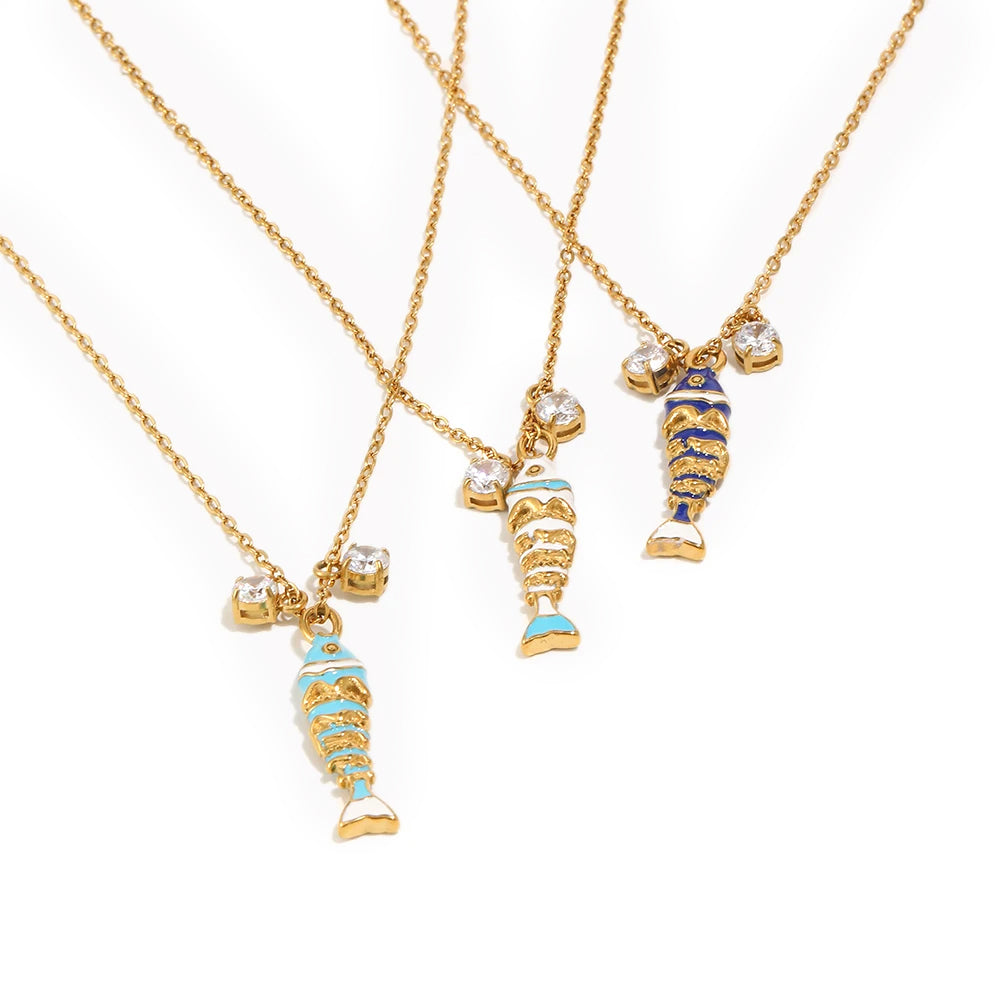 Enamel fish pendant necklace in three colorways, blue teal and navy enamel koi charms on gold chain, white background
