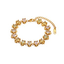 Gold multicolor square stone tennis bracelet on white background, pastel pink and champagne square stones in star-shaped prong settings, full bracelet shown with lobster clasp and extender chain, clean white background
