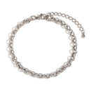 Silver textured rolo chain bracelet on white background, hammered round links with granular surface detail, lobster clasp and extender chain visible, cool light with soft shadow
