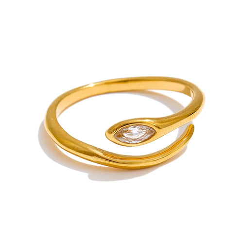 Gold marquise stone snake ring on white background, open adjustable band showing snake form with bezel-set marquise stone at head and fine tapered tail, warm light with long shadow beneath
