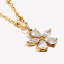 Close-up of crystal flower pendant necklace, marquise CZ petals in gold prong setting, detail shot
