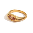 Gold marquise stone dome signet ring in brown colorway on white background, warm amber marquise-cut stone in mirror-polished dome band, side angle showing dome profile and band shoulder curve, long warm shadow
