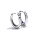 Pair of silver chunky hoop earrings on white background, thick mirror-polished tube hoops shown front and side angle, hinged clasp visible, cool light with soft shadow
