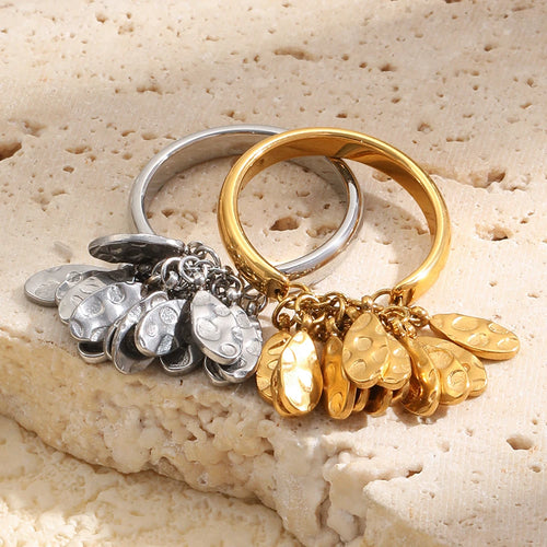 Gold and silver hammered fringe rings on textured stone surface, both colorways flat lay
