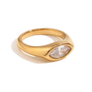 Gold marquise stone dome signet ring in white colorway on white background, clear crystal marquise-cut stone bezel-set in mirror-polished gold dome band, soft warm shadow
