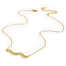 Gold pavé wave bar necklace on light grey-white background, overhead angled view showing full chain length with lobster clasp and extender at top, rhinestone wave pendant at bottom, fine O-chain links visible

